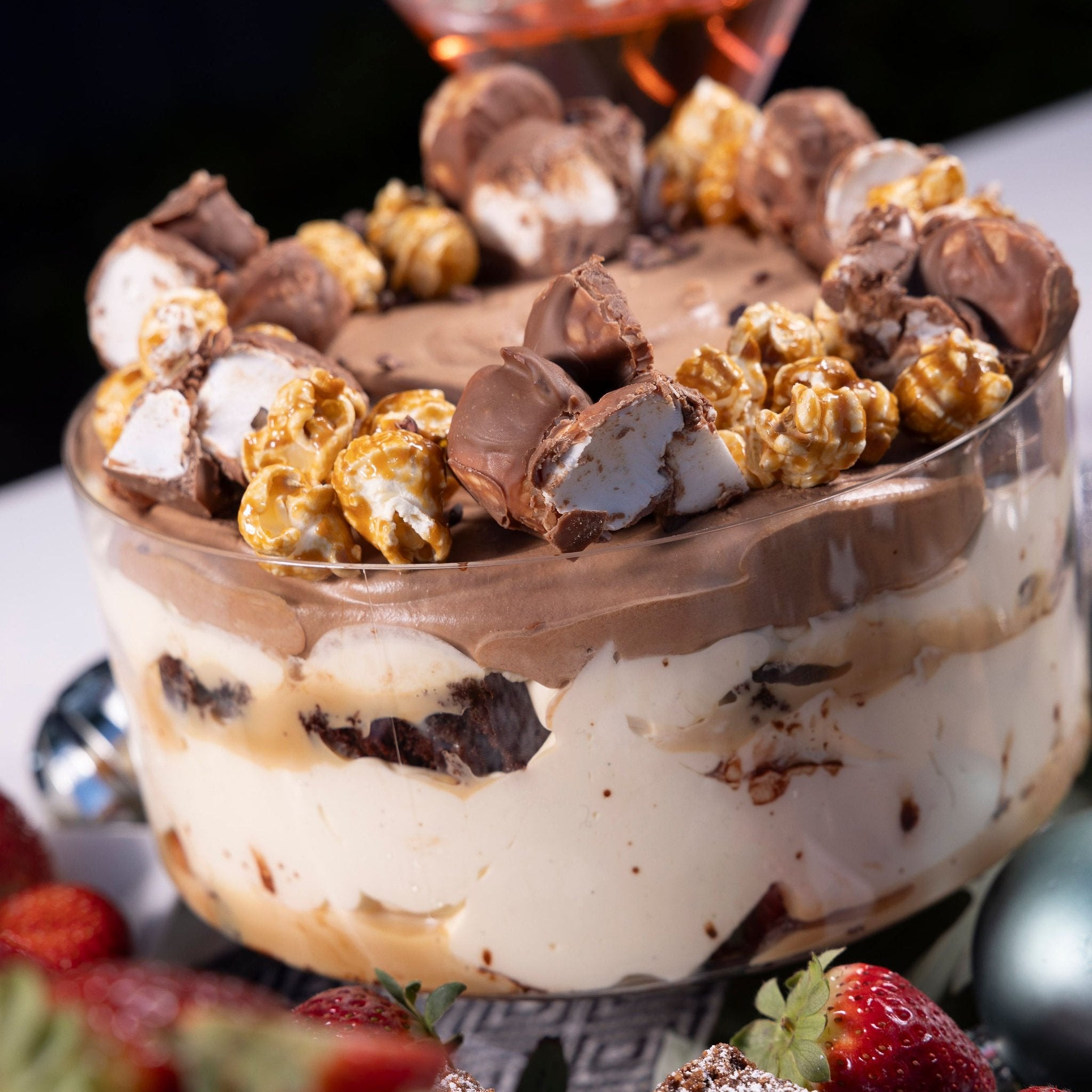 A chocolate trifle, topped with chocolate mousse, rocky road & caramel popcorn.